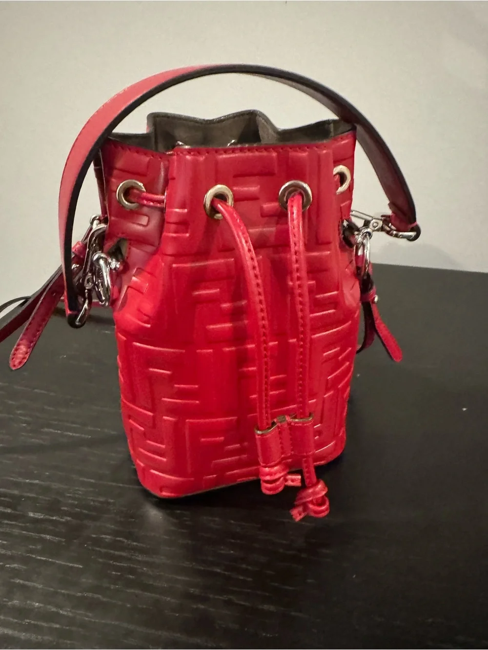 Fendi Mon Tresor mini bucket bag in a vibrant red hue with embossed FF logos